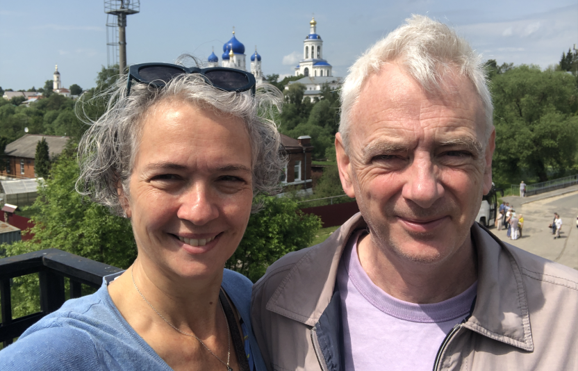 Alison and Malcolm Rogers on a balcony with cityscape behind