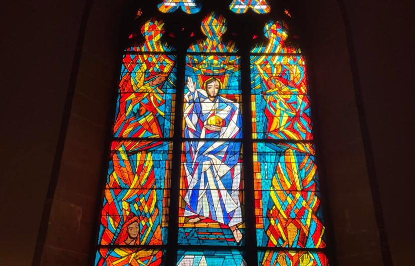 a stained glass window in the church building