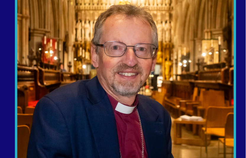 Bishop Robert smiles to camera