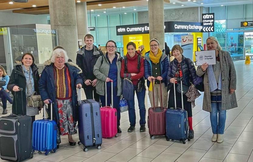Group of people standing at the airport with their luggage