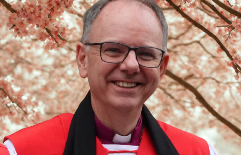 Bishop Andrew in front of a blossoming tree