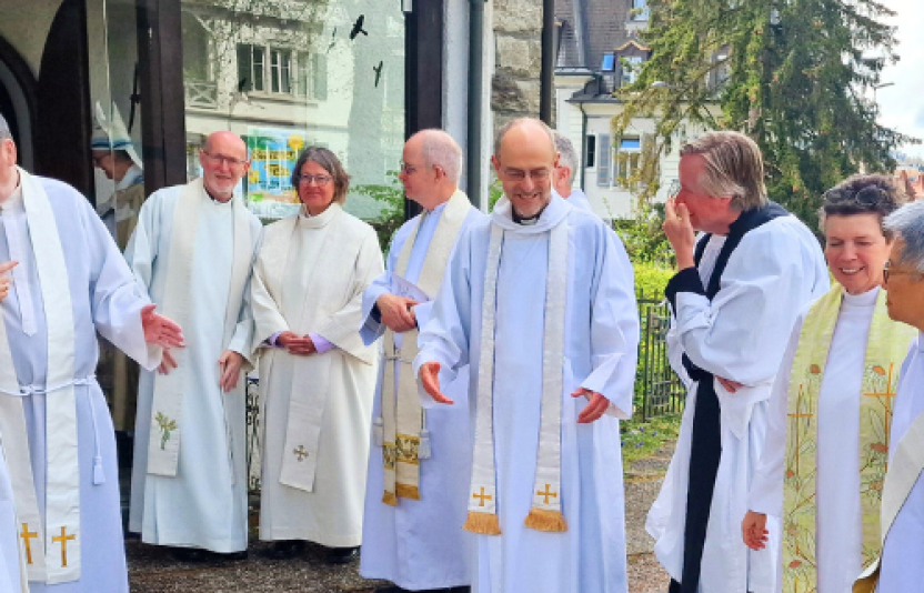 Clergy talking outside a church