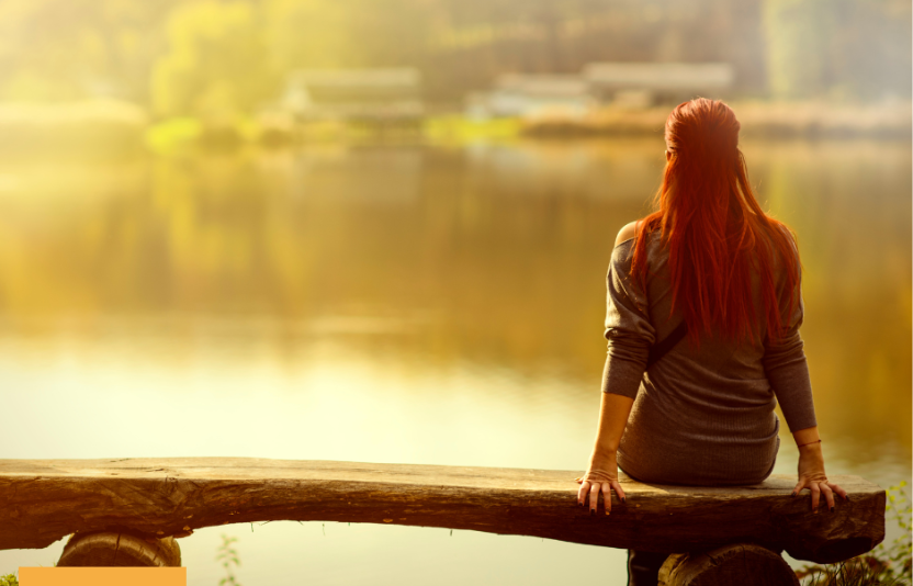 Person from behind looking at a lake