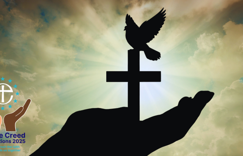 Silhouette of a hand holding a cross and dove