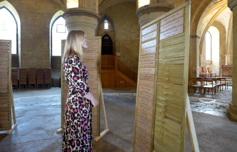 Lady looks at names on a memorial