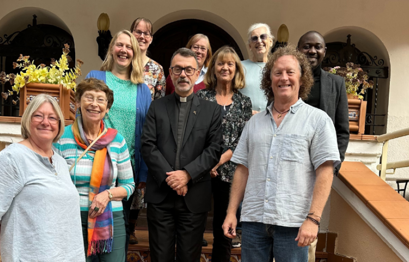 a group of people face the camera on stairs