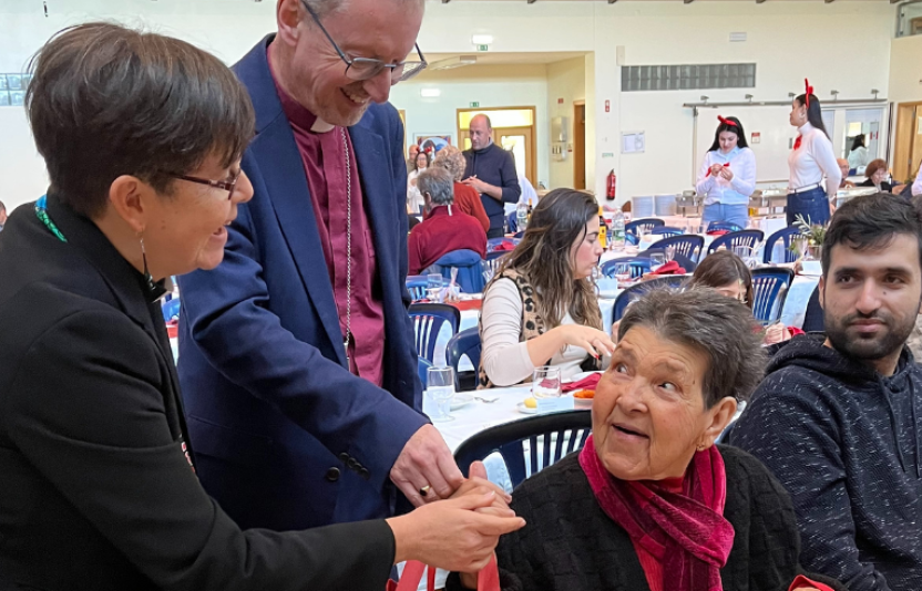 bishop and chaplain talking to an elderly lady