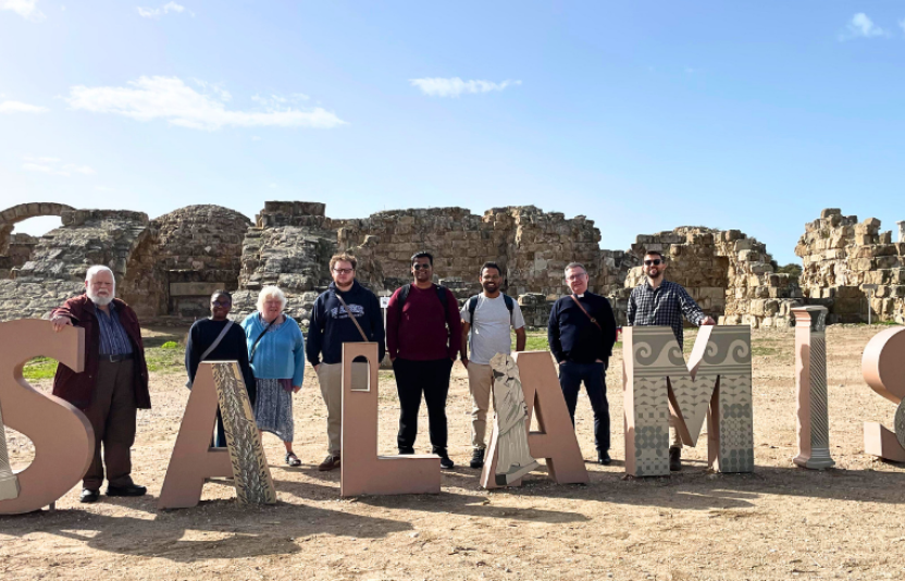 large letters spell Salamis with people standing with them