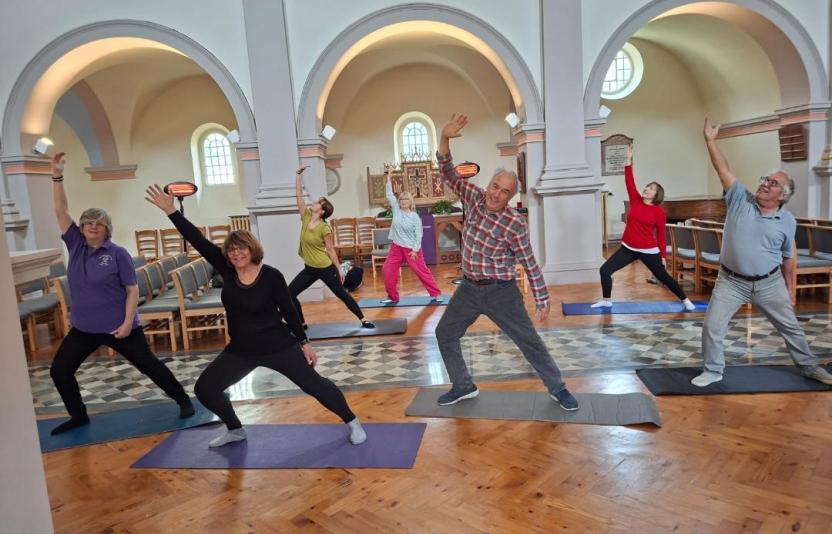 Photo of a group of people at an exercise class inside a church
