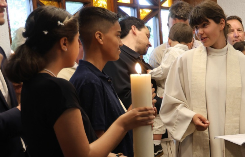 female chaplains talks to two young people
