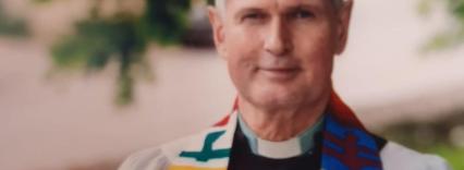Head and shoulders of Donald McFadyen looking to camera in robes
