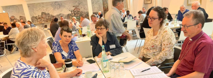 group of people listening to each other round a table