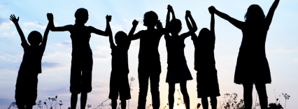 silhouettes of a row of children holding hands