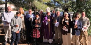 The congregation gathered around Bishop David.