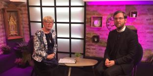 vicar in conversation with journalist