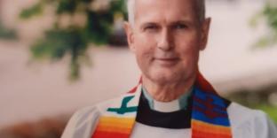 Head and shoulders of Donald McFadyen looking to camera in robes