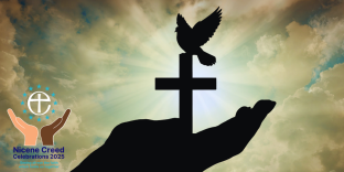 Silhouette of a hand holding a cross and dove