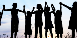 silhouettes of a row of children holding hands