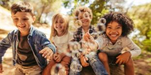 4 children blowing bubbles