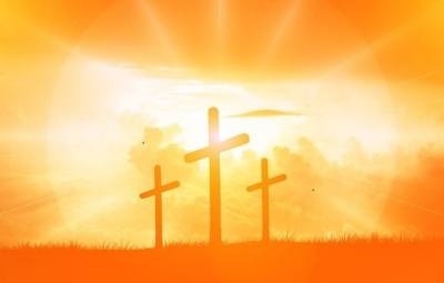 Three orange crosses on a hill.