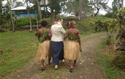 Three women walking together in Tanzania.
