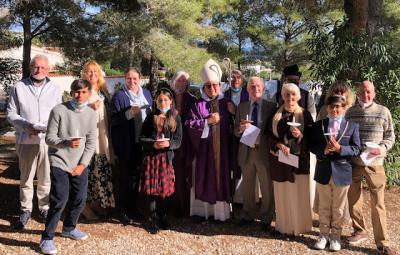 The congregation gathered around Bishop David.