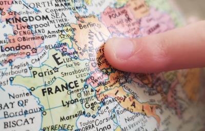 person touching a 3d globe