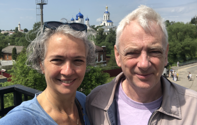 Alison and Malcolm Rogers on a balcony with cityscape behind