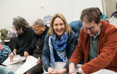 woman laughing making a paper hat