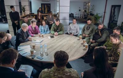 people sitting around a table, praying