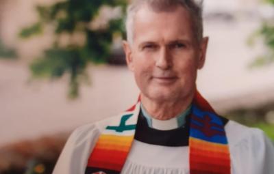 Head and shoulders of Donald McFadyen looking to camera in robes