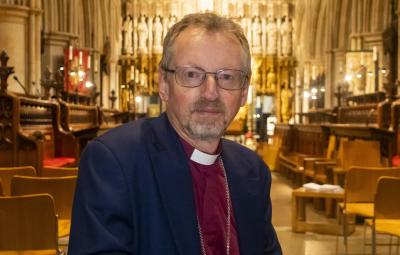 Bishop Robert looking to camera without smiling