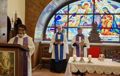 Three clergy conducting a service at the front of church