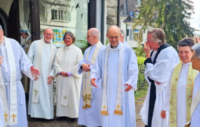 Clergy talking outside a church