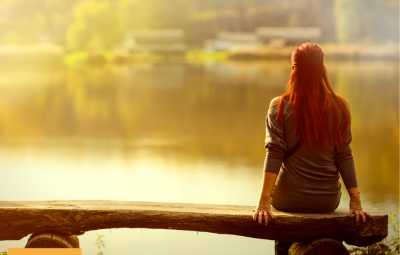Person from behind looking at a lake
