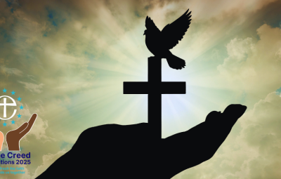Silhouette of a hand holding a cross and dove