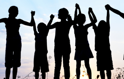 silhouettes of a row of children holding hands