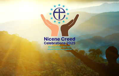 arms wide against a sunset and a logo