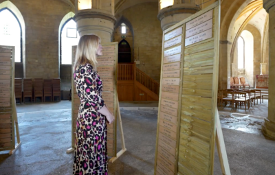 Lady looks at names on a memorial