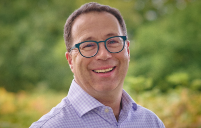 A man smiles to camera