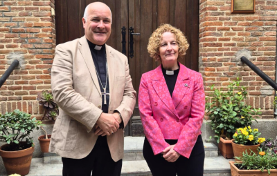 Archbishop and vicar in front of a church 