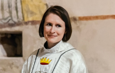 female chaplain smiles