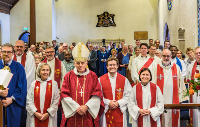 vicars and congregation look to camera
