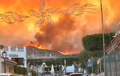 fire fills the sky behind shops