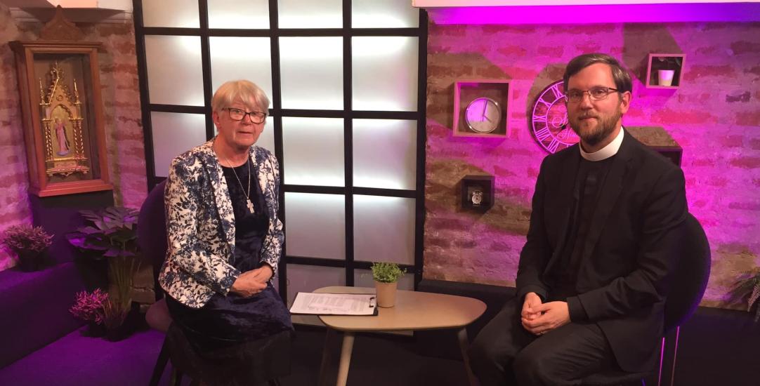 vicar in conversation with journalist