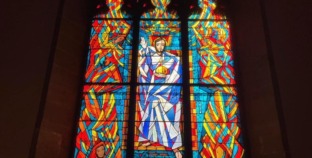 a stained glass window in the church building 