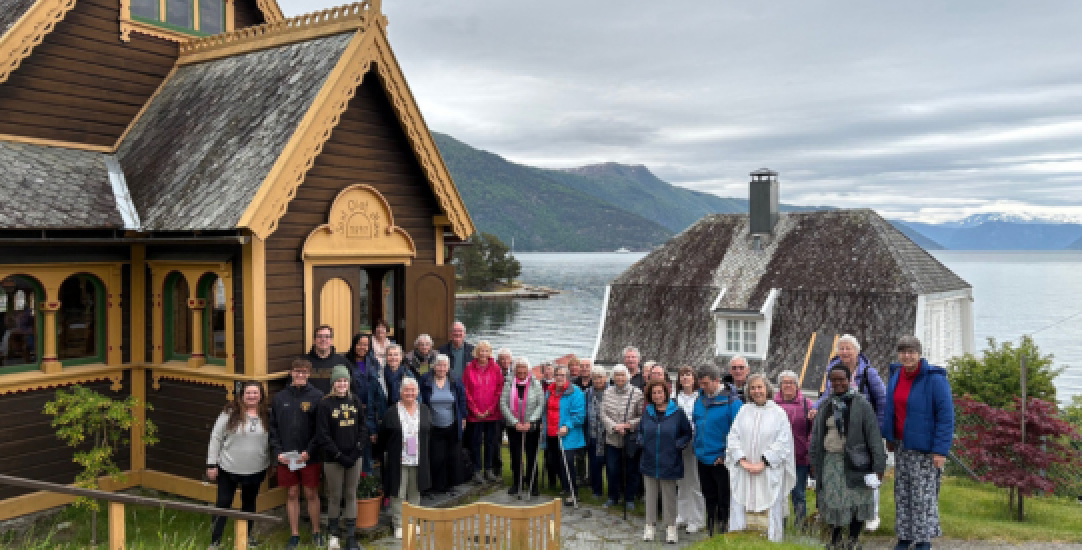 a row of people outside a church in balestrand