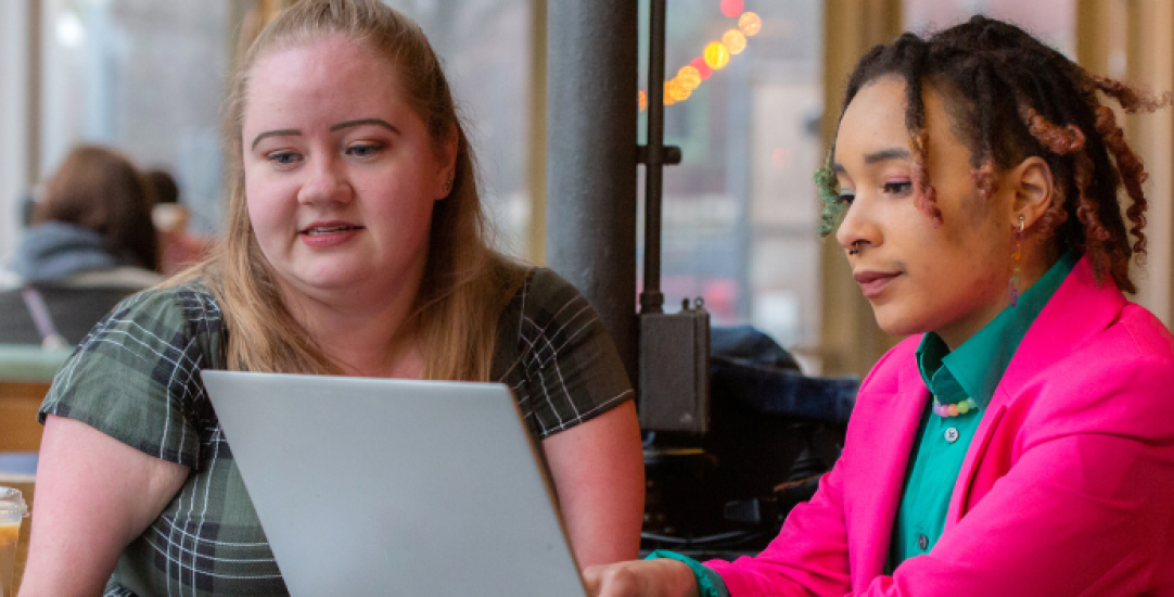 two girls on a laptop