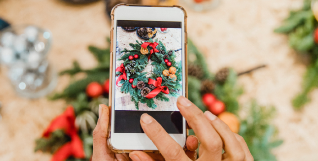 mobile phone taking a photo of christmas wreaths